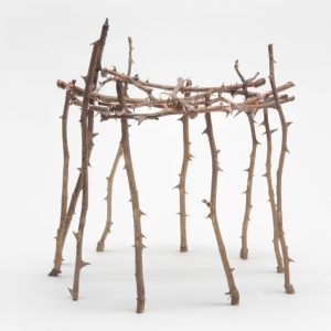 Claudia Losi, Asking Shelter (2016) Bronze casting of rose branches, silver approx 32 cm of diameter. The "Asking Shelter" installation consists of a series of hut-like structures of various sizes and numbers, created by assembling bronze castings of rose branches. The branches are from different types of rose bush, both wild and domestic, young and woody. Each branch is unique in shape and size. The structures resemble archetypal shelters with simple lines. Some seem to have been drawn by a child or conceived during a dream. While these shelters may provide protection, they can easily cause pain if one is not careful when inhabiting them.